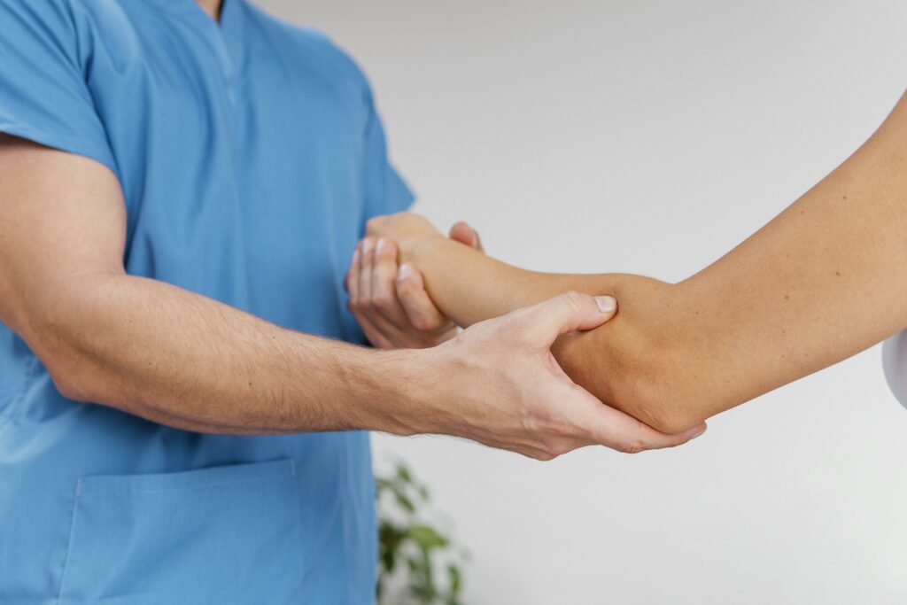 side-view-male-osteopathic-therapist-checking-female-patient-s-elbow-joint-movement